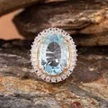 Macro detail of oval blue topaz ring with millennium cut on natural rock background - Natural Millennium Cut Topaz Ring