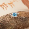 Elegant S925 sterling silver ring with an oval blue gemstone and white zircon accents - Swiss Blue Topaz