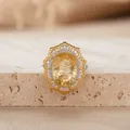 Macro view of Victoria style oval yellow gemstone ring with silver double halo - Natural Millennium Cut Citrine