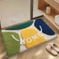 Colorful tufted absorbent bathroom mat with abstract shapes and white HOME lettering - 40*60cm / Colorful Stones