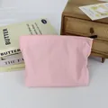 Minimalist pink nylon waterproof cosmetic bag with zipper in a cozy lifestyle setting. - Peach Pink