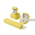 Elegant yellow PU leather jewelry boxes with crown clasps for rings, necklaces, and bracelets. - Turmeric