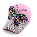 Detailed view of pink baseball cap with colorful rhinestone butterfly and studded brim. - Adult, Hat Circumference 58cm Adjustable / Pink