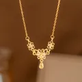 Elegant gold-tone necklace featuring a central butterfly and delicate flower motifs. - Hollow Butterfly (8348) / Gold