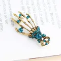 Vintage gold skeleton hand brooch accented with blue crystal rhinestones for fashion - Peacock Blue Skeleton Hand / Peacock Blue