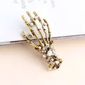Vintage creative skeleton hand brooch pin with sparkling crystals in gold finish - Champagne