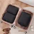 Black 3-piece travel packing cube set organized inside a suitcase for efficient packing - Three-Piece Set / Black
