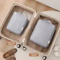 Two-piece grey travel packing cubes set for clothes organized inside a white suitcase - Two-Piece Set / Light Gray
