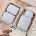 4-piece light blue travel luggage organizer bag set shown inside an open suitcase - Four-Piece Set / Foggy Blue