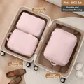 Set of 3 pink travel packing cubes organized inside an open suitcase for neat luggage - Three-Piece Set / Dusty Pink