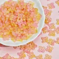 Close-up of 10mm translucent pink and yellow glass flower beads for DIY jewelry making - Orange Pink (L945)