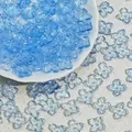 Close-up of 10mm light blue glass four-petal flower beads for DIY jewelry making. - Transparent Blue (L949)