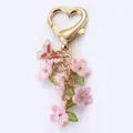 Elegant pink flower and butterfly keychain pendant with a gold heart shaped clasp - Flower String / Electroplated Pink