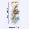 Elegant floral keychain featuring blue flowers and a butterfly charm for bag decoration - Flower String / 6.7cm / Iridescent Blue