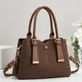 Side view of a brown textured faux leather handbag with elegant gold-tone hardware. - Patchwork Contrast Style / Coffee