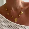 Elegant nautical gold charm necklace with starfish and sea shell pendants for women - Shell Necklace (T236_24) / Gold