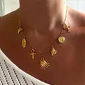 Gold charm necklace featuring sun heart and cross pendants displayed on model neck - Sun Necklace (T236_23) / Gold