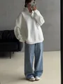 Woman in white oversized half-zip fleece sweatshirt with blue wide-leg denim jeans - S / Tops / White (Thin)