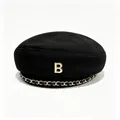 Detailed view of a black wool beret with gold B-logo and chain trim accessory. - M (56-58cm) / Black (Autumn/Winter Thick)