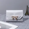 Elegant small silver tri-fold women's wallet featuring a stylish gold bow buckle detail - 3 Inch / Silver