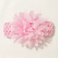 Detailed view of large pink chiffon flower on soft elastic hairband for infants - Pink