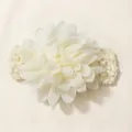Detail view of large white chiffon flower on soft knitted elastic headband for babies - Beige