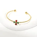 Elegant gold-toned open cuff bangle featuring red and green pear-cut zircon stones. - Cross Flower Style (ar5235) / Gold