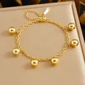 Gold-plated stainless steel charm bracelet featuring six polished gold spherical beads. - Six Sphere Pendant Style (B2054) / Gold