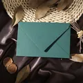 Detailed view of a premium teal linen-textured vintage envelope placed on brown satin - 1pc Linen Green Envelope / Green