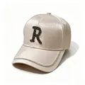 Macro view of champagne satin baseball cap with black rhinestone letter R detail - Adult, Hat Circumference 58cm Adjustable / Letter R Style / Pink