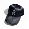 Close-up of black satin baseball cap with sparkling rhinestone R initial and brim trim - Adult, Hat Circumference 58cm Adjustable / Letter R Style / Black with Black Claw Chain