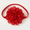 Detailed view of a red elastic baby headband with a large hollow lace flower - Red