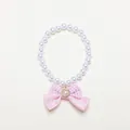 Close-up view of a pet pearl necklace featuring a pink gingham bow and heart charm - s-25cm / Pink Bowknot