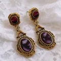 Macro view of vintage palace style gold earrings with purple oval stones. - Oval Design (8#) / Gold