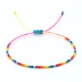 Handmade colorful rainbow seed bead bracelet with an adjustable neon pink cord closure - Rainbow Seed Bead Woven Style (MI-B200184A) / Rainbow Seed Beads