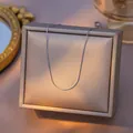 Elegant silver titanium steel thin link chain necklace displayed on a beige jewelry box - S-Chain (0.8) / Single Pack (40+5cm) / Steel