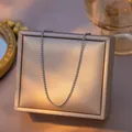 Minimalist silver-toned titanium steel ball chain necklace displayed on a golden box - Satellite Chain / Single Pack (40+5cm) / Steel