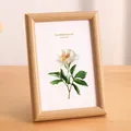 Minimalist light wood tabletop photo frame featuring an elegant white floral art print - 10" / Natural Wood Color