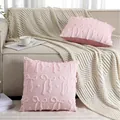 Detail showing soft pink quilted plush pillowcase with bow patterns on a sofa - 45x45cm / Pink Bowknot