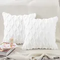 Close-up detail of two white plush quilted throw pillow covers on a cozy knitted sofa - 18x18 Inch / White Round
