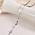 Detail macro shot of stainless steel rosary necklace with black beads and silver cross - Virgin Mary Style / 3mm Ball / Two-tone Black
