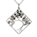 Detailed macro view of handmade wire-wrapped tree of life pendant with grey stones - Black Rutilated Quartz