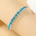 Elegant silver-tone tennis bracelet featuring vibrant blue and clear rhinestones. - Lake Blue Silver Plated