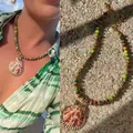 Close-up detail of natural stone beaded necklace featuring a large shell pendant in beach style - Camouflage Beads Edged Red Shell (38+5cm)