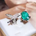 Exquisite adjustable bird ring featuring a large oval green gemstone and sparkling pavé accents - White Gold (Green Main Stone)