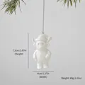 White ceramic Highland cow hanging ornament with Santa hat design for Christmas decor - Cow