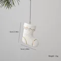 White ceramic Christmas stocking ornament with gold trim and snowflake detail - Boots