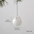 White ceramic Christmas ball ornament with bow design and embossed snowflake texture - Bow Knot Ball