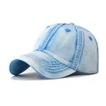 Detail shot of a light blue washed distressed denim baseball cap with curved brim - M / Denim Blue