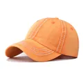 Detailed view of orange distressed washed denim baseball cap with white contrast stitching - M / Denim Yellow